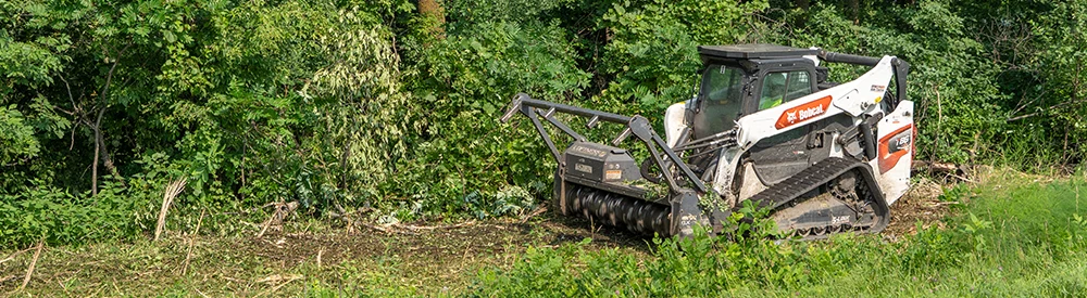 Loftness Battle Ax S Series mulching along a tree line